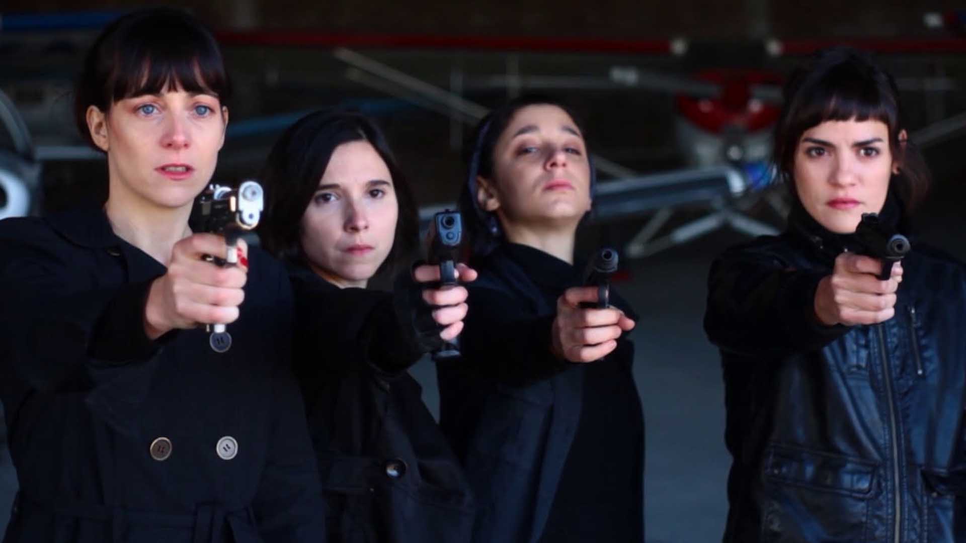 Four women holding guns in the movie La Flor