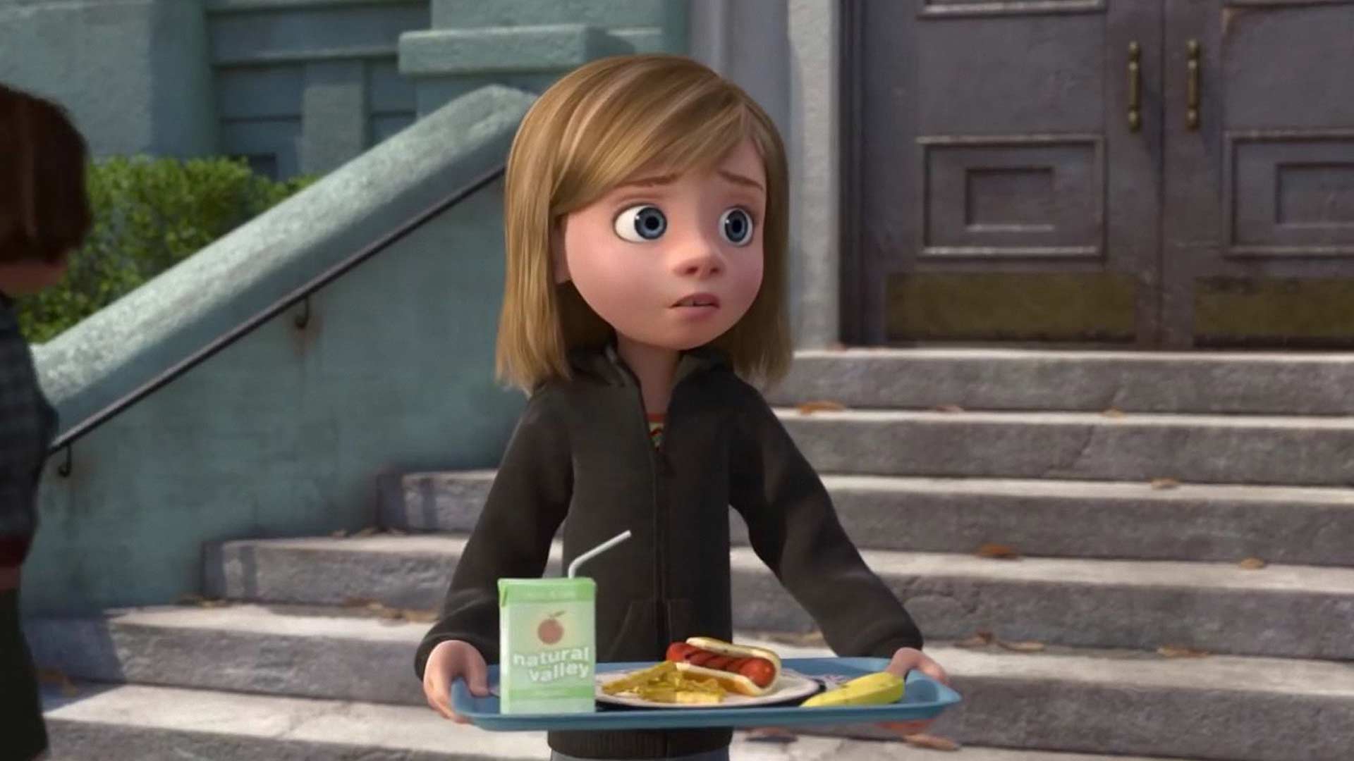 Riley carrying a tray of food in the animation inside out