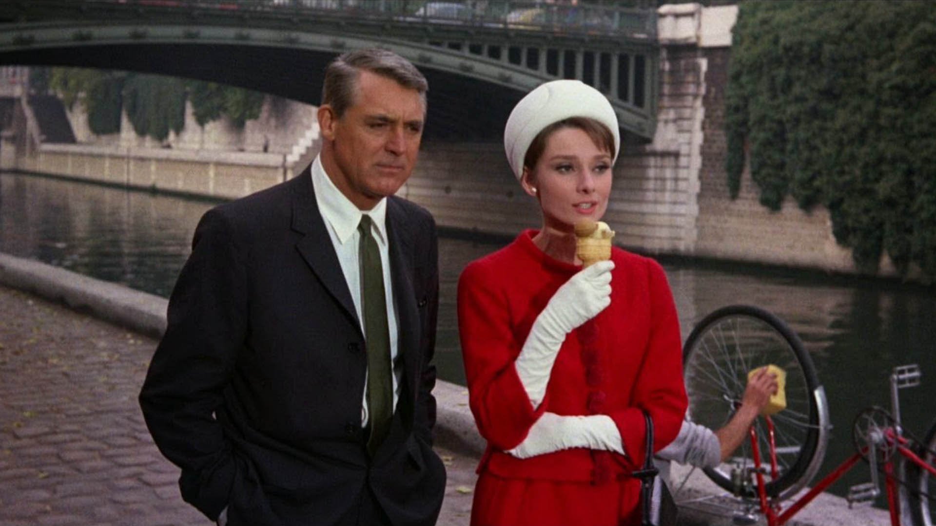 Audrey Hepburn and Carrie Grant walk by the water in Charade
