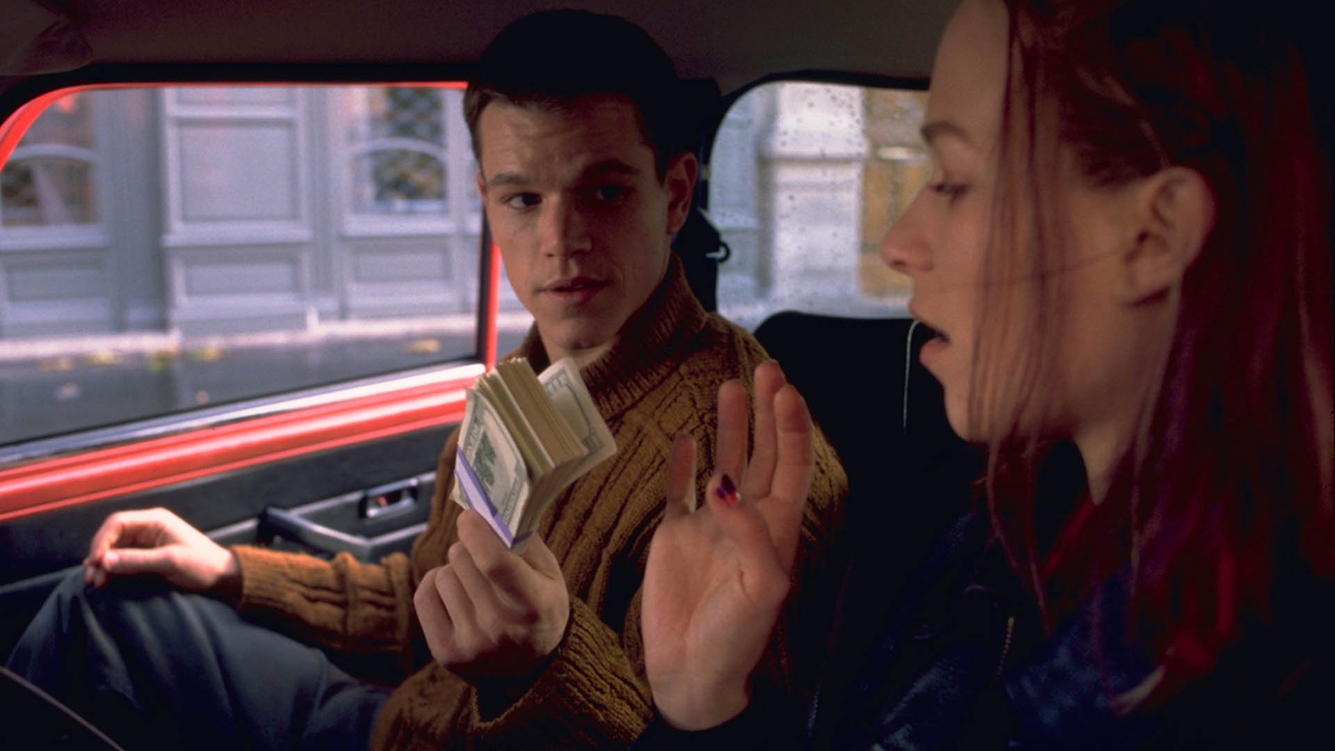 Matt Damon is giving money to Franca Putnte in The Bourne Identity
