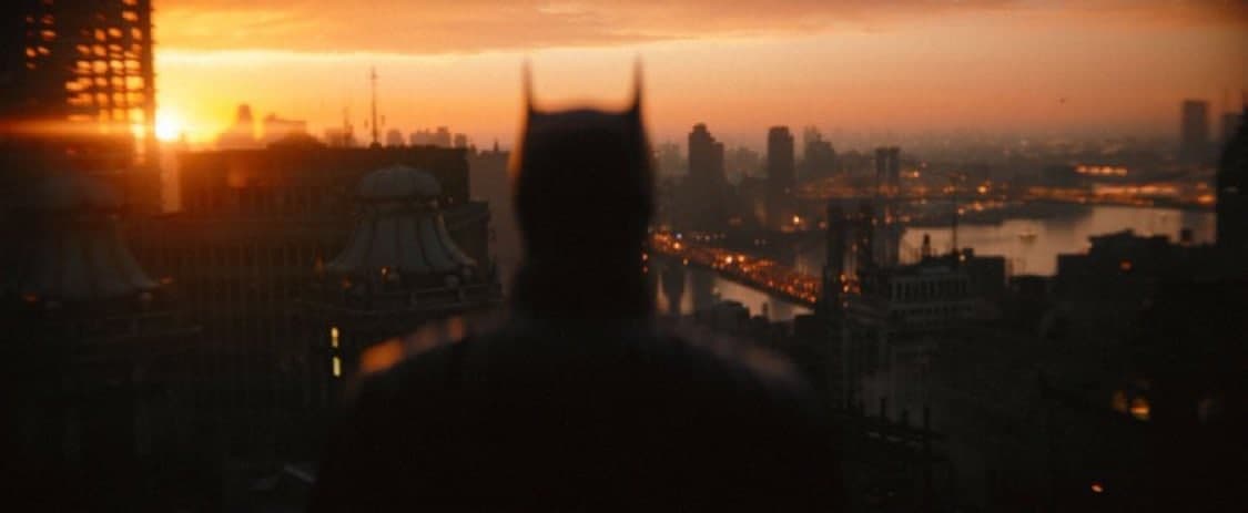 Batman, starring Robert Pattinson, watches Gotham City in The Batman
