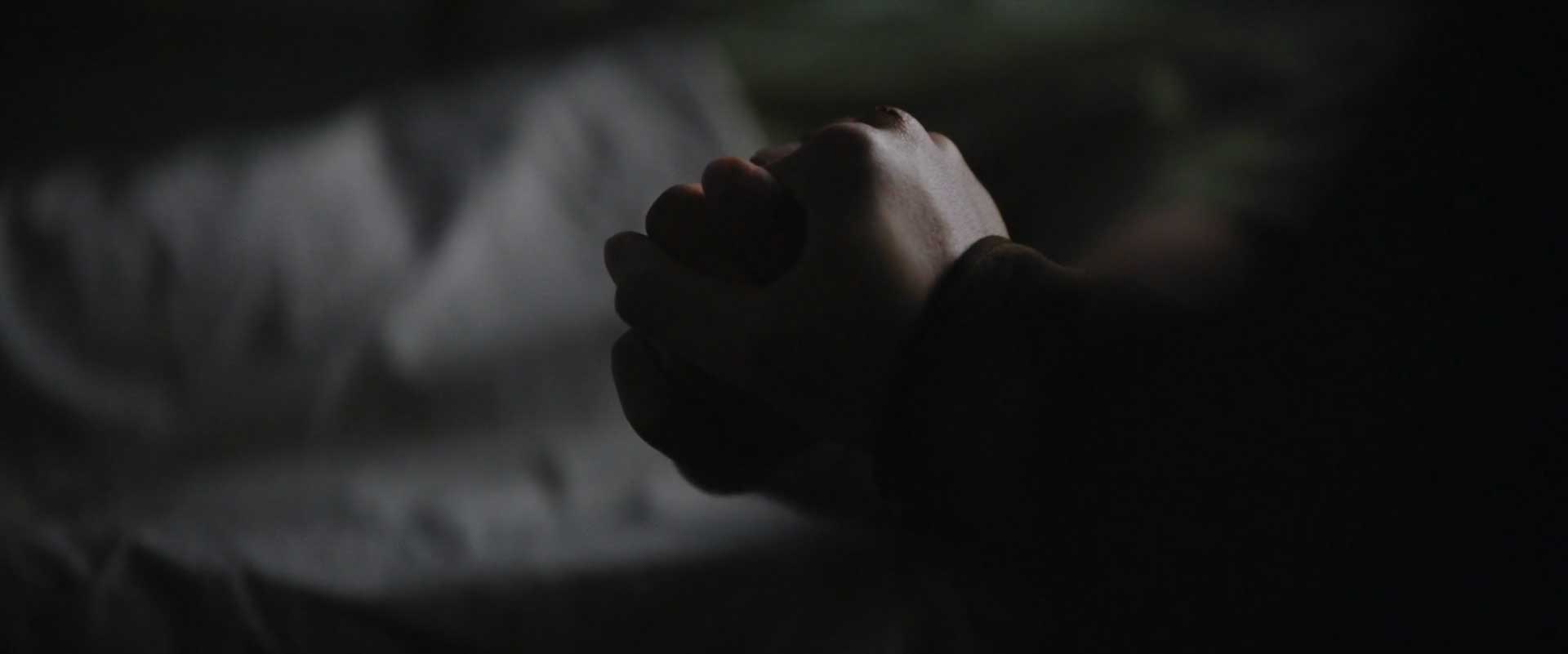 The hands of two characters in The Batman starring Robert Pattinson
