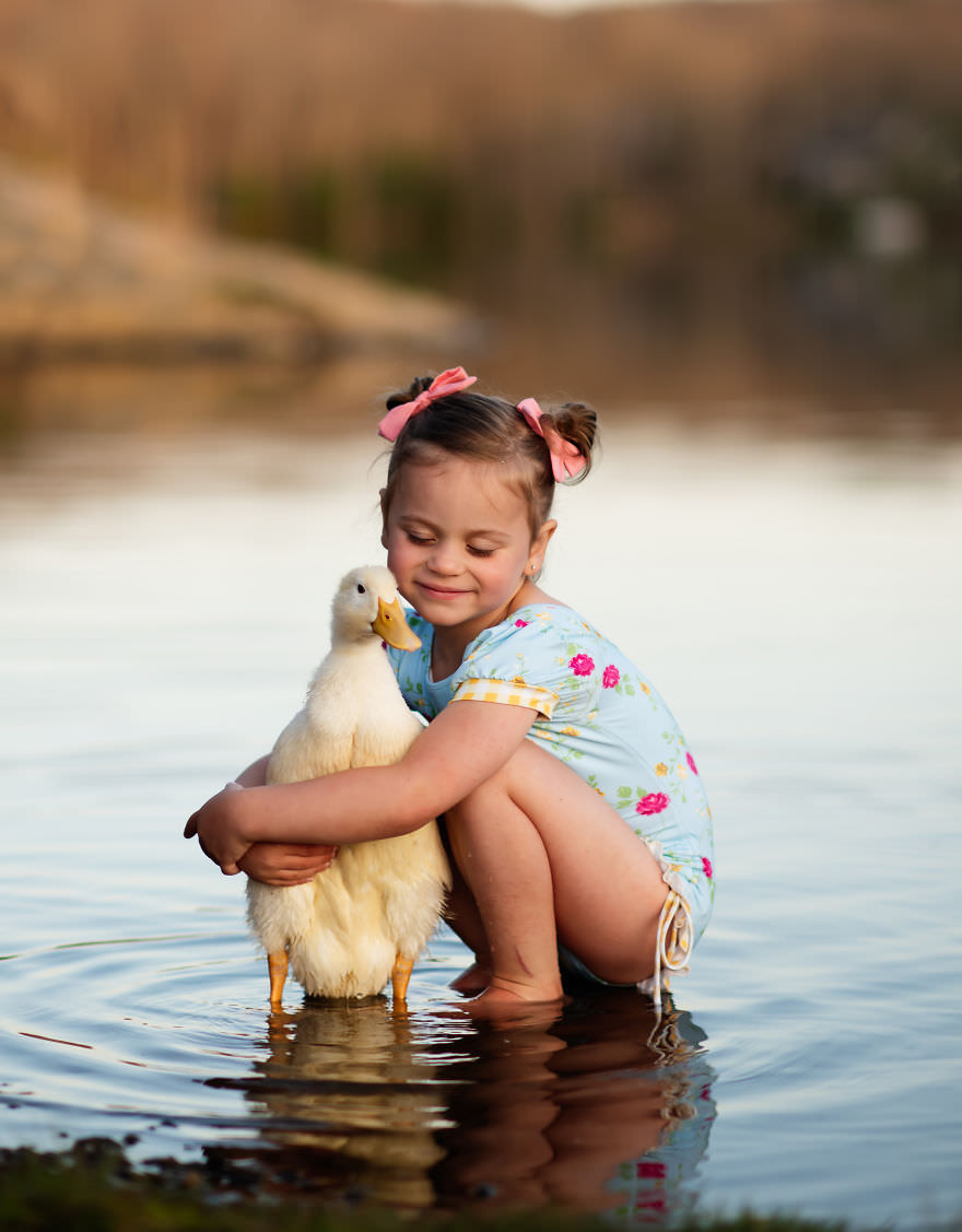 The interaction of children and animals, duck and girl / Andrea Martin