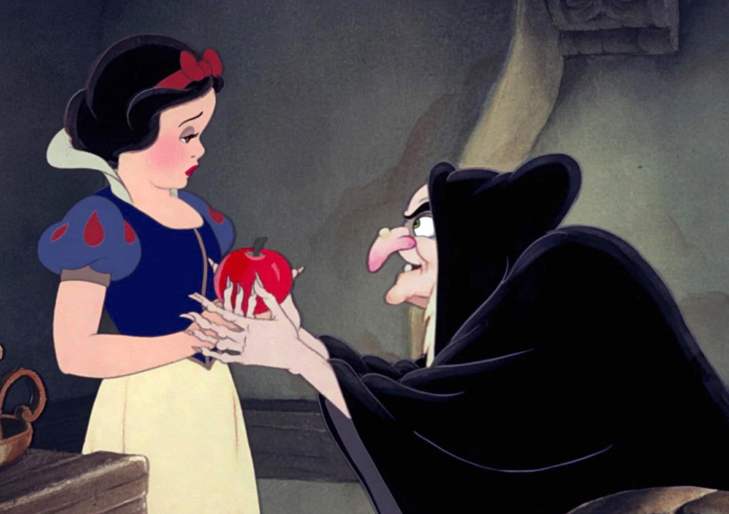 The old witch is offering a poisoned apple to Snow White